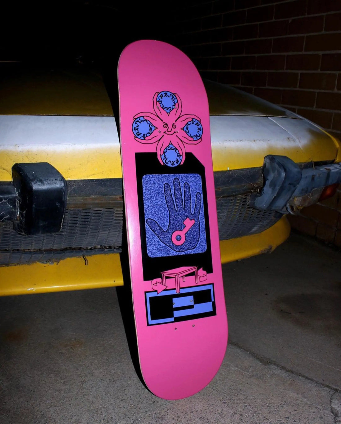 Skateboard deck leaning against a car